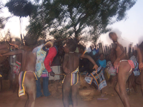 Action shot of dancing at Mpate's  cultural village. A must for Project volunteers to discover the diverse and  special venda culture. Note the baby strapped on to mum's back whilst she played the drum.	